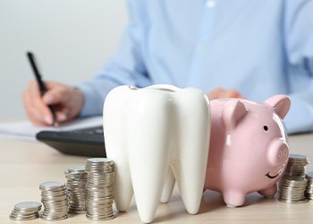 Coins next to a piggy bank