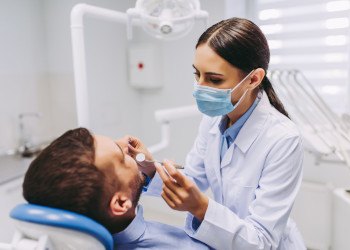 Dentist examining patient's teeth