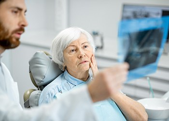 Dentist and patient looking at X-ray together